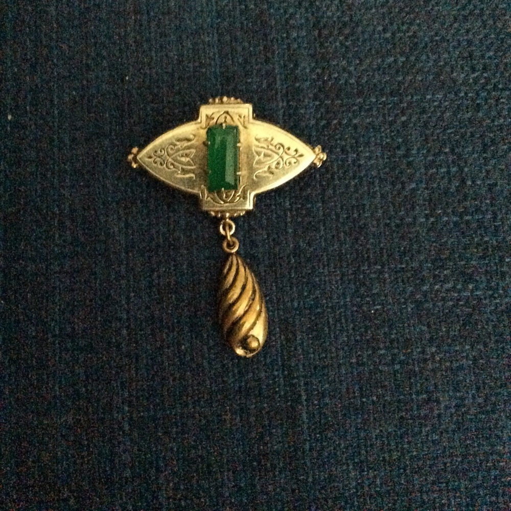 Vintage gold-tone pin with green stone